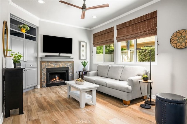 8507 E Heatherview Ln, Orange, CA 92869 - living room with a ceiling fan, crown molding, recessed lighting, light wood-style floors, and a fireplace