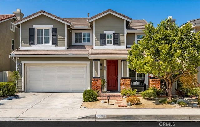 8507 E Heatherview Ln, Orange, CA 92869 - view of front facade with concrete driveway, an attached garage, and a tiled roof