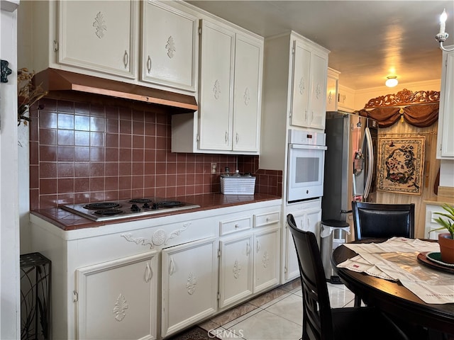 2064 E Campus Way, Hemet, CA 92544 - kitchen with white oven, electric stovetop, freestanding refrigerator, and backsplash