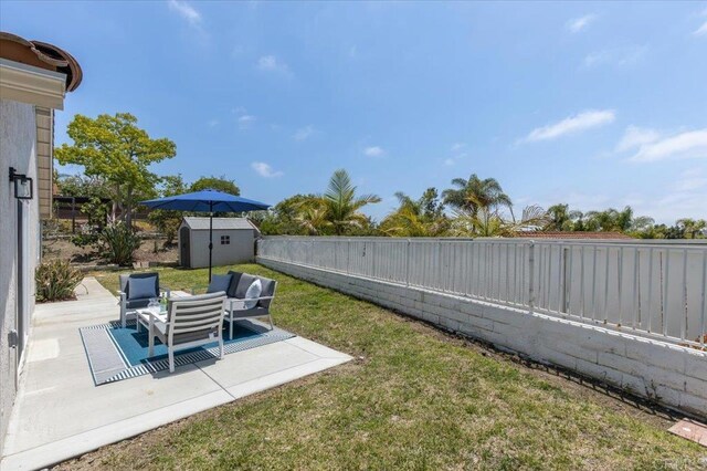 7911 Terraza Disoma, Carlsbad, CA 92009 - fenced backyard with a storage shed, a patio, and an outdoor living space