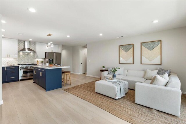 7911 Terraza Disoma, Carlsbad, CA 92009 - living room with light wood-style flooring and recessed lighting