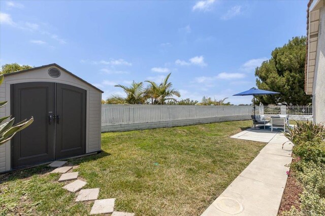 7911 Terraza Disoma, Carlsbad, CA 92009 - fenced backyard featuring a storage shed and a patio area