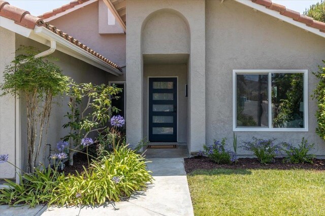 7911 Terraza Disoma, Carlsbad, CA 92009 - doorway to property with stucco siding and a tile roof