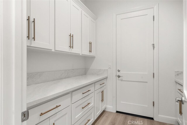 5 Gazania Ct, Chico, CA 95926 - kitchen featuring white cabinetry, light wood-type flooring, and light stone countertops