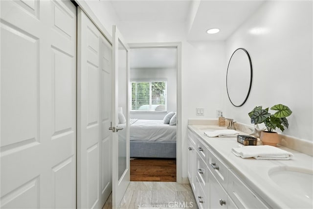 1967 Rolling Vista Dr Unit 58, Lomita, CA 90717 - ensuite bathroom featuring double vanity, recessed lighting, and marble look tile flooring
