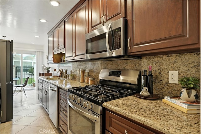 1967 Rolling Vista Dr Unit 58, Lomita, CA 90717 - kitchen with stainless steel appliances, tasteful backsplash, light tile patterned flooring, light stone countertops, and recessed lighting