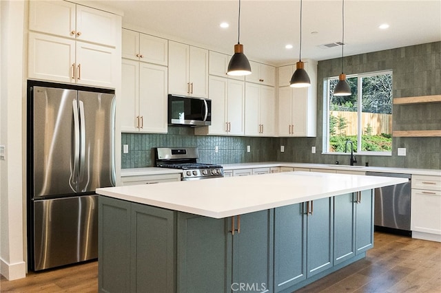 904 Waggoner Rd, Paradise, CA 95969 - kitchen with stainless steel appliances, wood finished floors, light countertops, white cabinets, and recessed lighting
