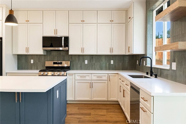 904 Waggoner Rd, Paradise, CA 95969 - kitchen with stainless steel appliances, light countertops, wood finished floors, pendant lighting, and backsplash