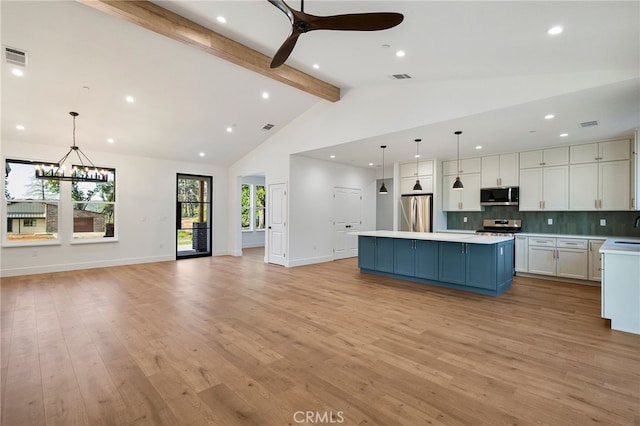904 Waggoner Rd, Paradise, CA 95969 - kitchen featuring stainless steel appliances, beam ceiling, white cabinets, a center island, and light countertops