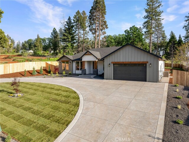 904 Waggoner Rd, Paradise, CA 95969 - view of front of home with board and batten siding, an attached garage, and driveway