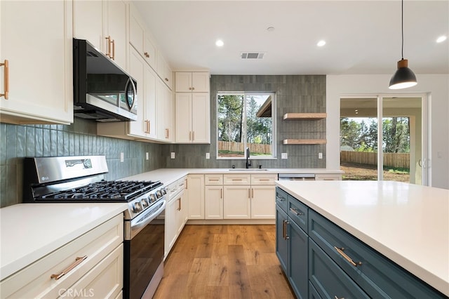 904 Waggoner Rd, Paradise, CA 95969 - kitchen featuring appliances with stainless steel finishes, light countertops, healthy amount of natural light, white cabinetry, and recessed lighting
