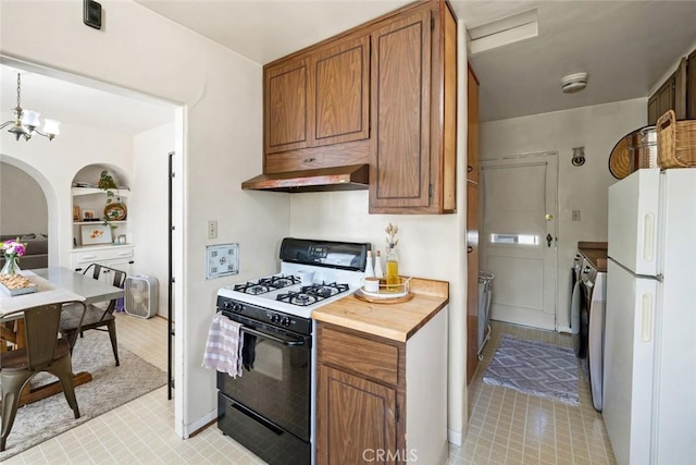 480 Pacific St, San Luis Obispo, CA 93401 - kitchen featuring range with gas stovetop, freestanding refrigerator, washing machine and clothes dryer, range hood, and brown cabinets
