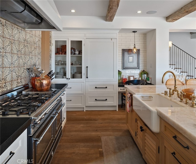 30671 Steeplechase Dr, San Juan Capistrano, CA 92675 - kitchen featuring range with two ovens, exhaust hood, beamed ceiling, dark wood-style flooring, and white cabinetry