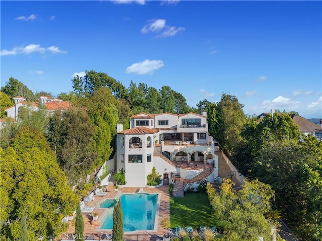 30671 Steeplechase Dr, San Juan Capistrano, CA 92675 - back of property featuring a balcony, stairway, a chimney, stucco siding, and a patio area