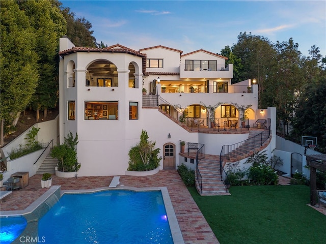 30671 Steeplechase Dr, San Juan Capistrano, CA 92675 - rear view of house with stairs, stucco siding, an outdoor pool, and a patio area