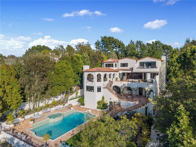 30671 Steeplechase Dr, San Juan Capistrano, CA 92675 - rear view of property featuring stucco siding, a balcony, a patio, a chimney, and stairs