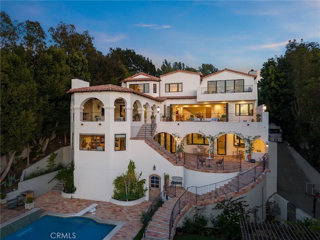 30671 Steeplechase Dr, San Juan Capistrano, CA 92675 - rear view of house with stairway, a patio, a balcony, and stucco siding