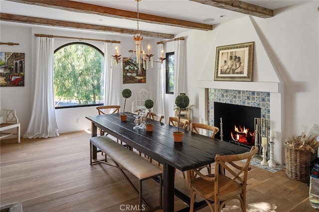 30671 Steeplechase Dr, San Juan Capistrano, CA 92675 - dining room featuring light wood-style floors, a chandelier, beam ceiling, and a tiled fireplace