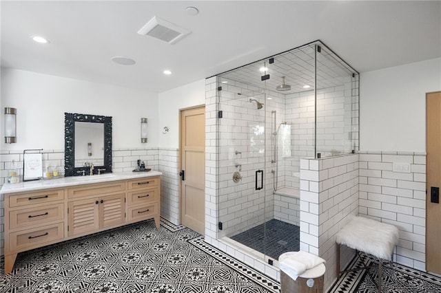 30671 Steeplechase Dr, San Juan Capistrano, CA 92675 - full bath with tile walls, vanity, a stall shower, recessed lighting, and tile patterned flooring