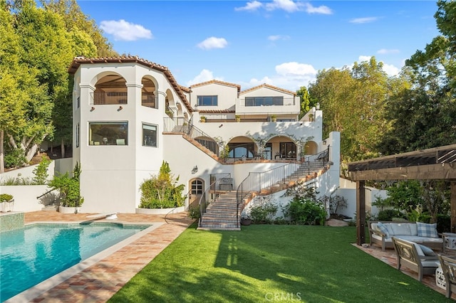 30671 Steeplechase Dr, San Juan Capistrano, CA 92675 - back of house featuring stairs, an outdoor living space, stucco siding, a lawn, and an outdoor pool