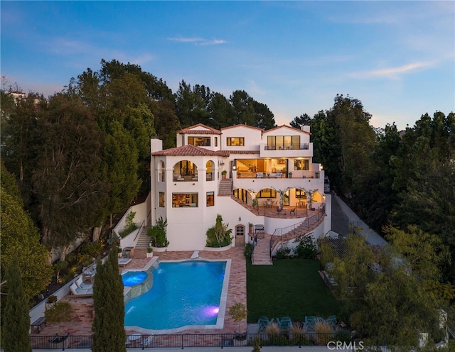 30671 Steeplechase Dr, San Juan Capistrano, CA 92675 - back of house with stairs, a balcony, a chimney, a patio, and stucco siding