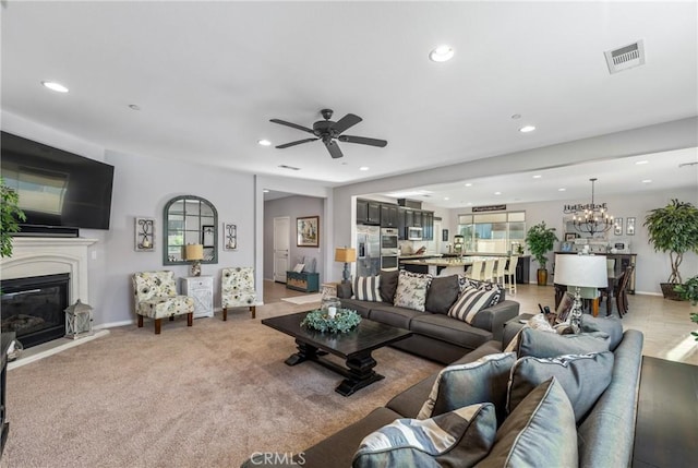 11409 Calle Positas, Jurupa Valley, CA 91752 - living room with a glass covered fireplace, recessed lighting, ceiling fan, a chandelier, and light carpet