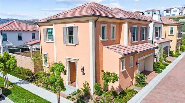 183 Plum Lily, Irvine, CA 92618 - view of property exterior with stucco siding, an attached garage, a tile roof, and a standing seam roof