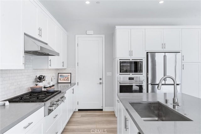 183 Plum Lily, Irvine, CA 92618 - kitchen featuring stainless steel appliances, under cabinet range hood, white cabinetry, light wood-style floors, and recessed lighting