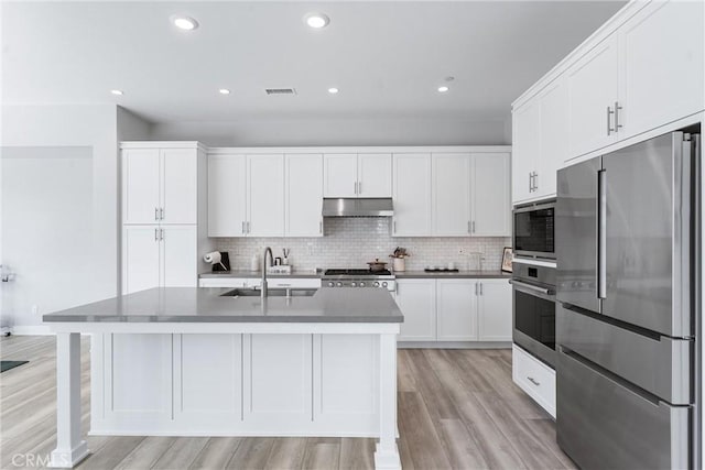 183 Plum Lily, Irvine, CA 92618 - kitchen featuring stainless steel appliances, under cabinet range hood, light wood-style flooring, white cabinets, and recessed lighting