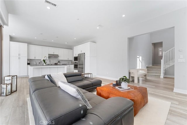 183 Plum Lily, Irvine, CA 92618 - living room with light wood-style floors, stairway, and recessed lighting