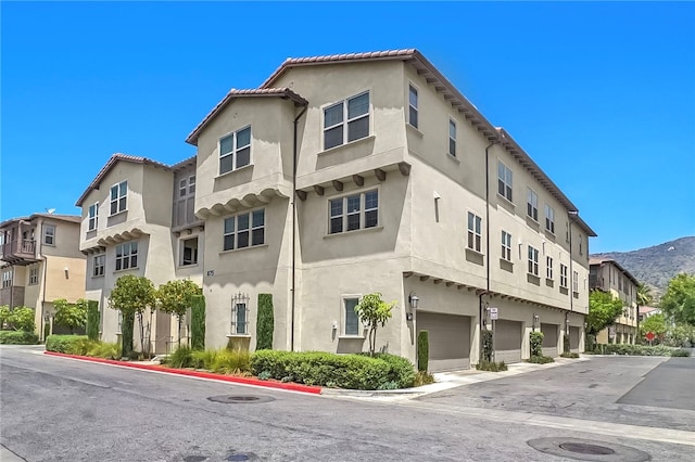 875 Iris Way Unit B, Azusa, CA 91702 - view of property with an attached garage, a mountain view, and a residential view