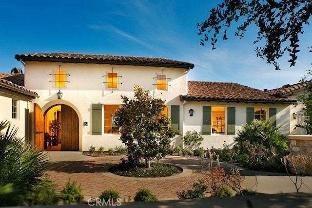 875 Iris Way Unit B, Azusa, CA 91702 - back of property with stucco siding, a tiled roof, and curved driveway