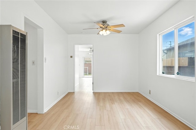 15322 Casimir Ave, Gardena, CA 90249 - empty room featuring a heating unit, ceiling fan, light wood-type flooring, and plenty of natural light