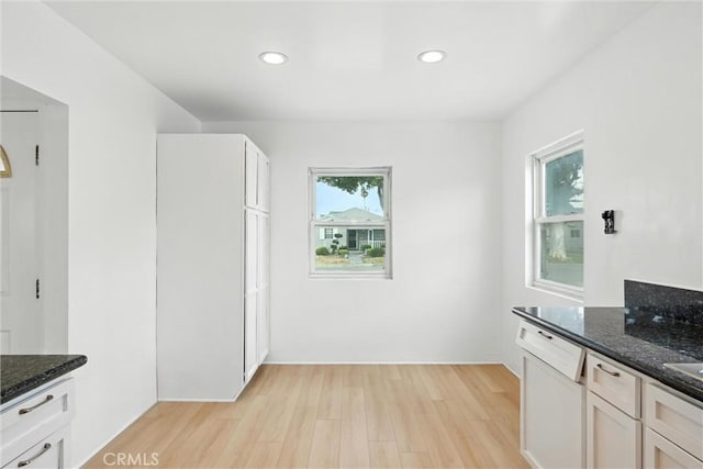 15322 Casimir Ave, Gardena, CA 90249 - kitchen with light wood-style flooring, dark stone counters, dishwasher, recessed lighting, and white cabinetry