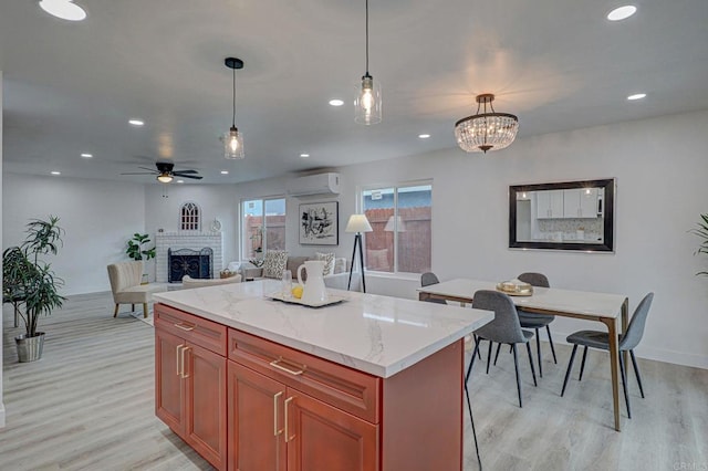 1320 Vinca Way, San Diego, CA 92113 - kitchen with a wall mounted AC, a brick fireplace, light wood finished floors, hanging light fixtures, and recessed lighting