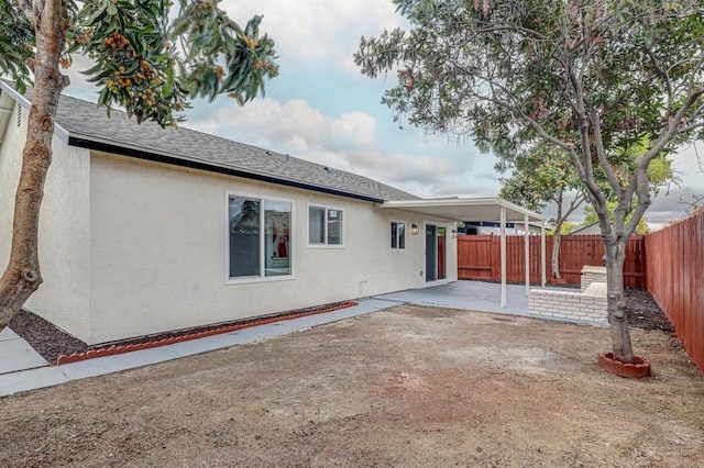 1320 Vinca Way, San Diego, CA 92113 - back of property featuring stucco siding, a patio area, a fenced backyard, and roof with shingles