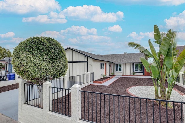 1320 Vinca Way, San Diego, CA 92113 - view of front facade with a fenced front yard, board and batten siding, and a shingled roof