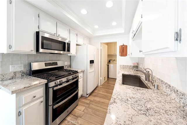 20004 Waverly Glen St Unit 46, Yorba Linda, CA 92886 - kitchen with stainless steel appliances, light wood-style flooring, white cabinets, a tray ceiling, and decorative backsplash