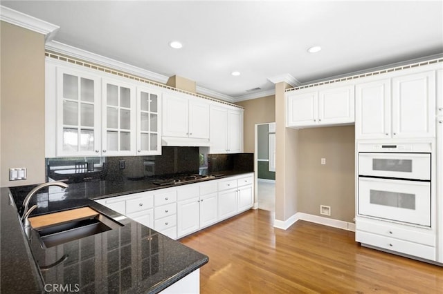 21658 Canyon Heights Cir, Saugus, CA 91390 - kitchen featuring ornamental molding, stainless steel gas stovetop, decorative backsplash, white cabinets, and glass insert cabinets