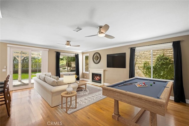 21658 Canyon Heights Cir, Saugus, CA 91390 - recreation room featuring crown molding, a glass covered fireplace, light wood-type flooring, billiards table, and ceiling fan