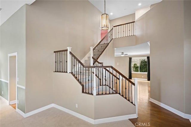 21658 Canyon Heights Cir, Saugus, CA 91390 - staircase featuring a high ceiling, wood finished floors, and recessed lighting