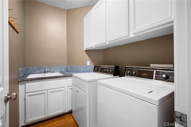 21658 Canyon Heights Cir, Saugus, CA 91390 - washroom featuring cabinet space, washing machine and clothes dryer, and wood finished floors