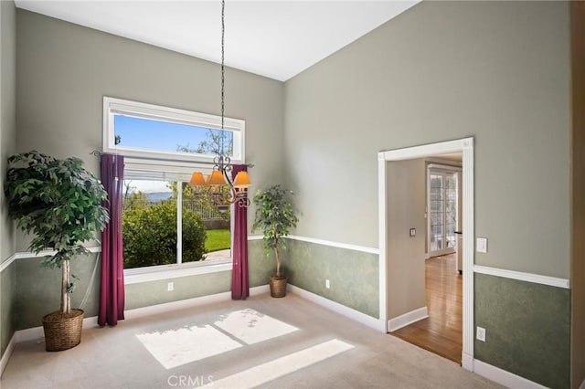 21658 Canyon Heights Cir, Saugus, CA 91390 - unfurnished dining area featuring a chandelier, plenty of natural light, and carpet floors
