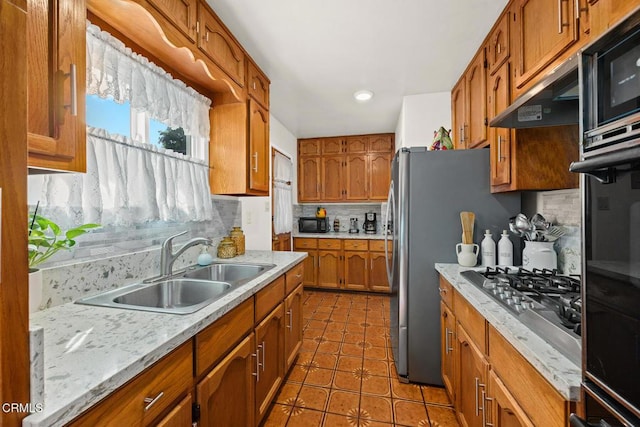 215 Bridewell St, Los Angeles, CA 90042 - kitchen featuring decorative backsplash, brown cabinetry, light countertops, tile patterned floors, and recessed lighting