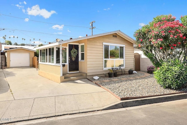 215 Bridewell St, Los Angeles, CA 90042 - view of front facade featuring driveway, an outdoor structure, and a detached garage
