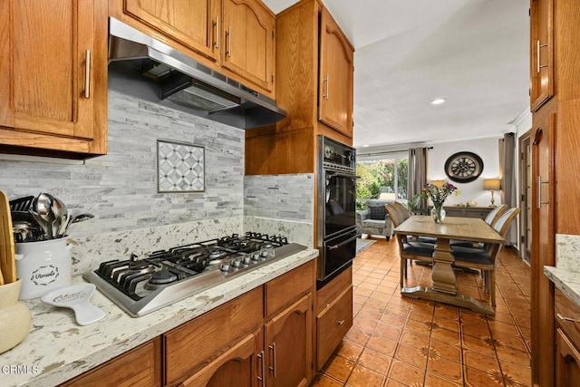 215 Bridewell St, Los Angeles, CA 90042 - kitchen featuring under cabinet range hood, stainless steel gas stovetop, a warming drawer, black oven, and light tile patterned flooring