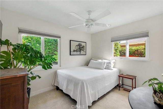 1212 Dover Dr, Newport Beach, CA 92660 - bedroom featuring multiple windows, light carpet, and a ceiling fan