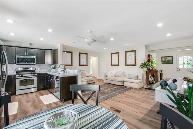 1212 Dover Dr, Newport Beach, CA 92660 - living room with recessed lighting, light wood-type flooring, and ceiling fan