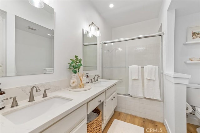 17202 Corbina Ln Unit 103, Huntington Beach, CA 92649 - bathroom with an enclosed shower, double vanity, and wood finished floors