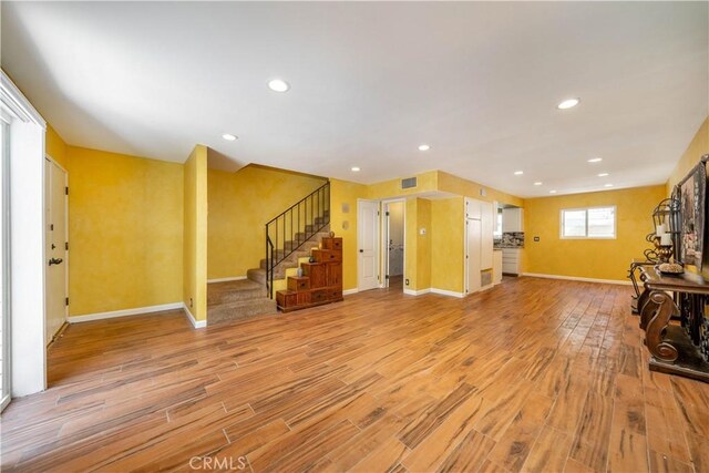 14947 Dickens St Unit 3, Sherman Oaks, CA 91403 - unfurnished living room with light wood-type flooring, stairs, and recessed lighting